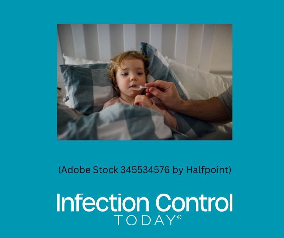 An ill child in bed receiving liquid antibiotics.  (Adobe Stock 345534576 by Halfpoint)